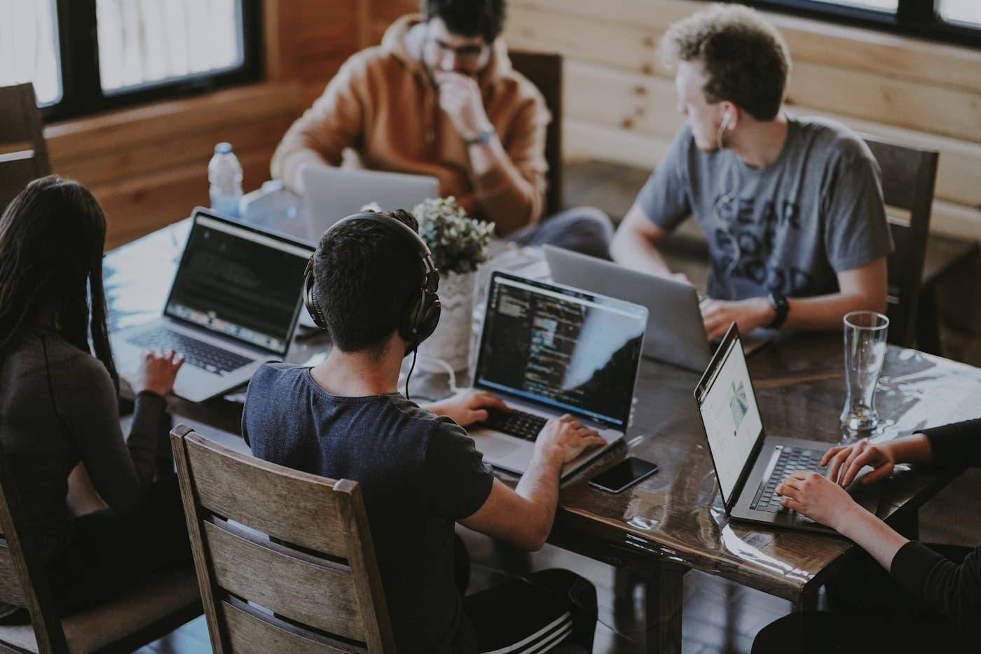 A distributed team working with headsets and laptops