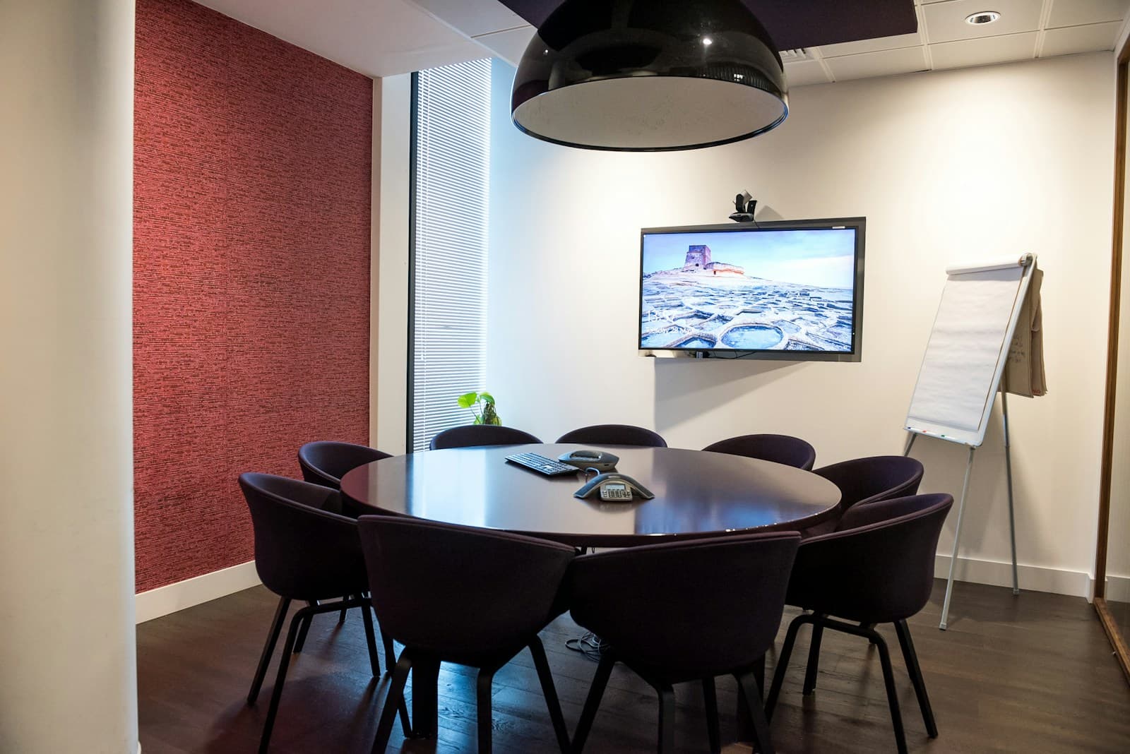 A meeting room with a conference phone on the table